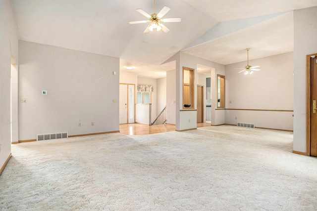 unfurnished living room with a ceiling fan, light carpet, baseboards, and lofted ceiling