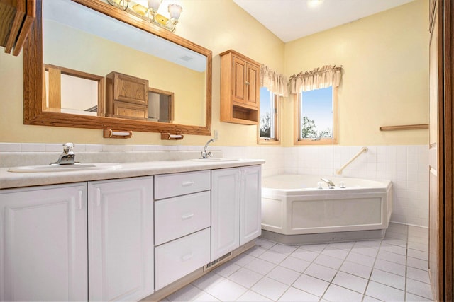 full bathroom featuring tile patterned flooring, double vanity, a garden tub, tile walls, and a wainscoted wall