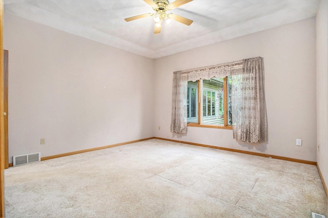 spare room featuring carpet flooring, a ceiling fan, and baseboards