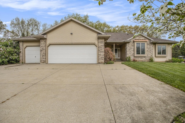 view of front of property featuring a garage, driveway, brick siding, a front yard, and roof with shingles