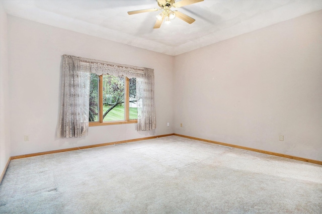 unfurnished room featuring carpet flooring, ceiling fan, and baseboards