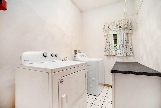 washroom with washing machine and dryer and light tile patterned flooring