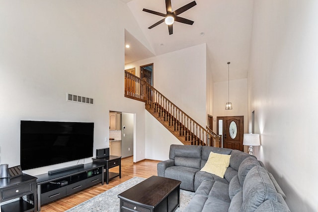 4024 Austin Ct, Lapeer, MI 48446 - living room with high vaulted ceiling, a ceiling fan, light wood-style flooring, stairs, and baseboards