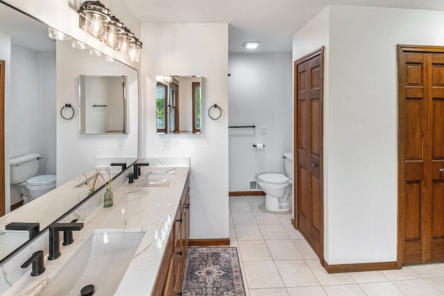 4024 Austin Ct, Lapeer, MI 48446 - bathroom with toilet, baseboards, tile patterned flooring, and double vanity
