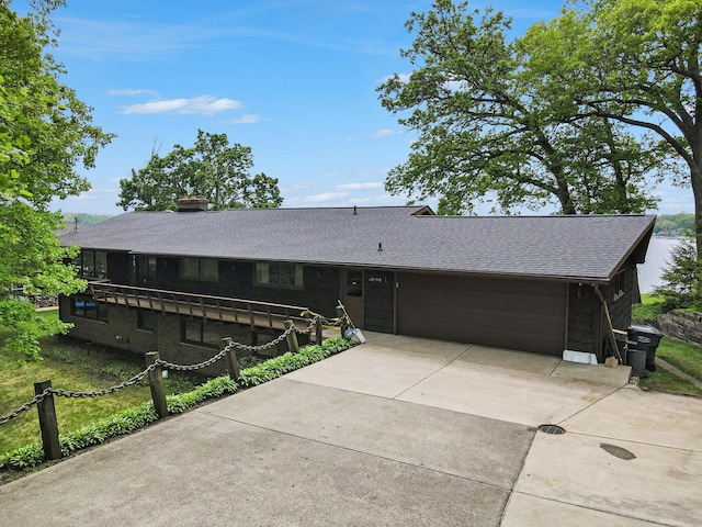 10706 Portage Rd, Portage, MI 49002 - view of front of home featuring driveway, a garage, a shingled roof, and a chimney