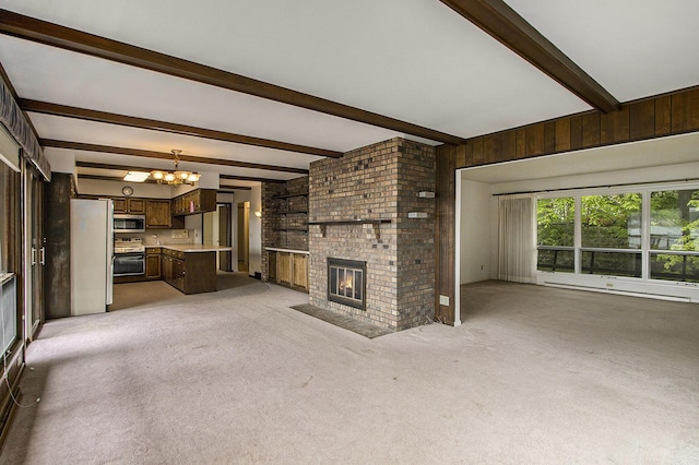 10706 Portage Rd, Portage, MI 49002 - unfurnished living room featuring a chandelier, beam ceiling, a fireplace, a baseboard radiator, and light colored carpet