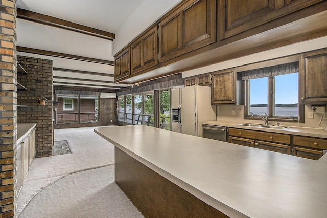 10706 Portage Rd, Portage, MI 49002 - kitchen with a sink, white refrigerator with ice dispenser, light carpet, stainless steel dishwasher, and beamed ceiling