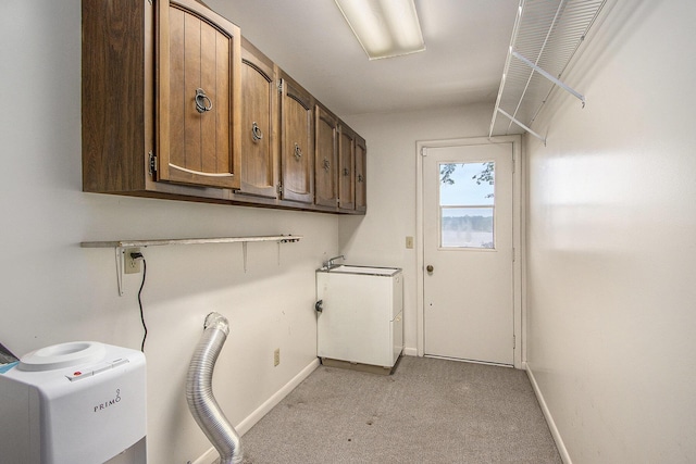 10706 Portage Rd, Portage, MI 49002 - washroom with cabinet space, light colored carpet, and baseboards