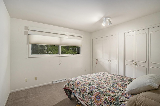 10706 Portage Rd, Portage, MI 49002 - bedroom featuring two closets, carpet floors, baseboard heating, and baseboards