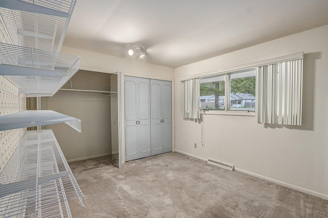 10706 Portage Rd, Portage, MI 49002 - unfurnished bedroom with carpet floors, baseboards, two closets, and a baseboard radiator