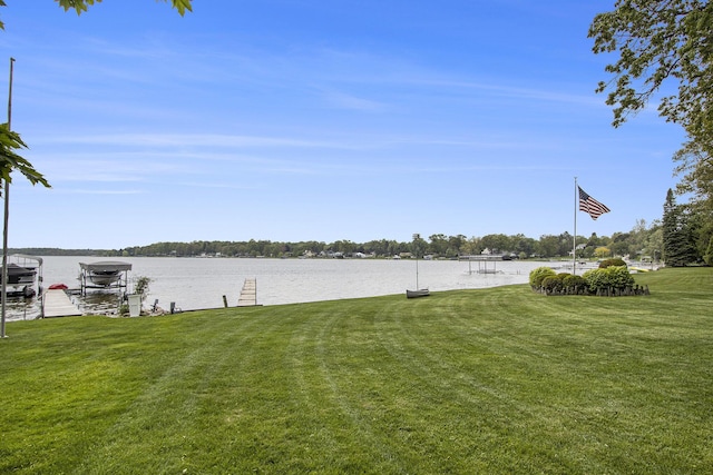 10706 Portage Rd, Portage, MI 49002 - view of grassy yard featuring a dock, a water view, and boat lift
