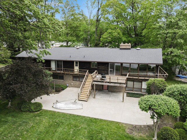 10706 Portage Rd, Portage, MI 49002 - rear view of property featuring a patio, stairs, a deck, a chimney, and roof with shingles
