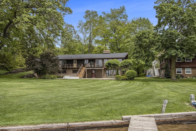 10706 Portage Rd, Portage, MI 49002 - rear view of property with a deck, a lawn, a chimney, stairs, and brick siding