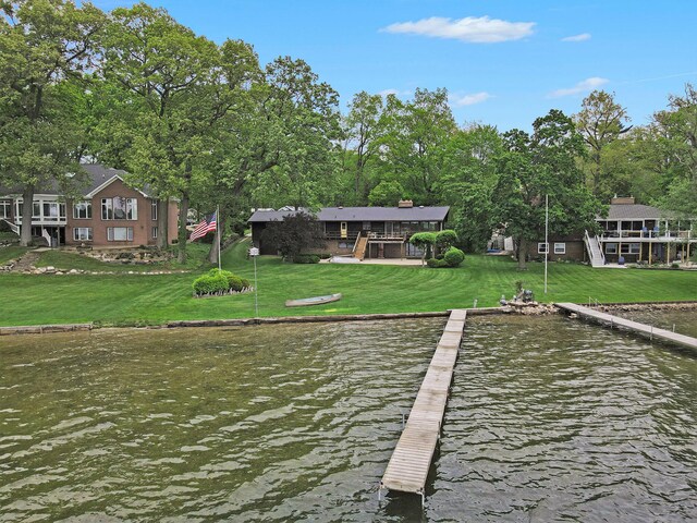 10706 Portage Rd, Portage, MI 49002 - dock area featuring a water view, a lawn, and view of scattered trees