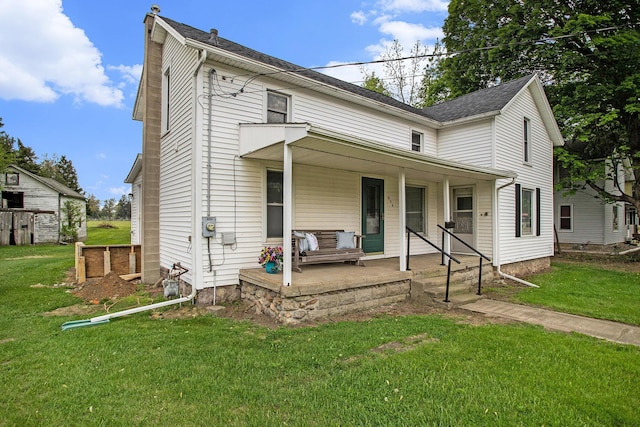 view of front of house with a porch and a front lawn