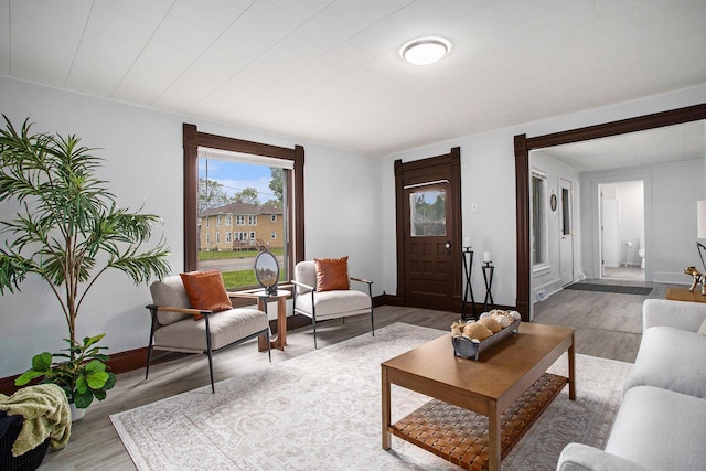 living room featuring light wood finished floors and baseboards