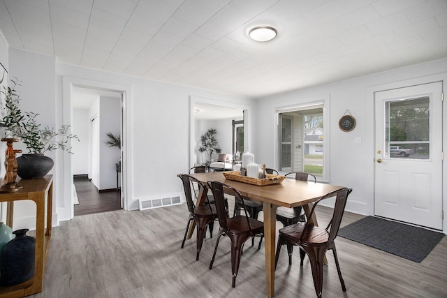 dining room featuring wood finished floors and baseboards