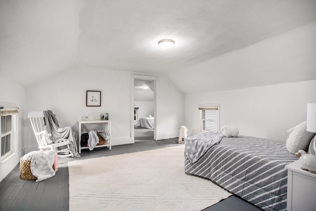 bedroom featuring vaulted ceiling and baseboards