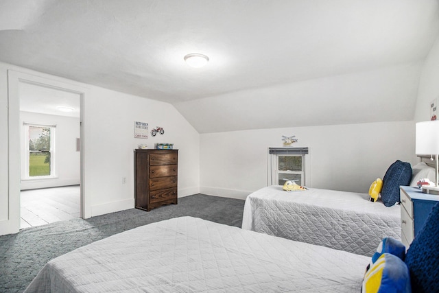 bedroom featuring carpet flooring, lofted ceiling, and baseboards