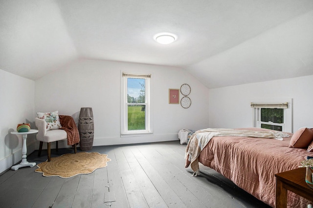 bedroom featuring vaulted ceiling, light wood finished floors, and baseboards