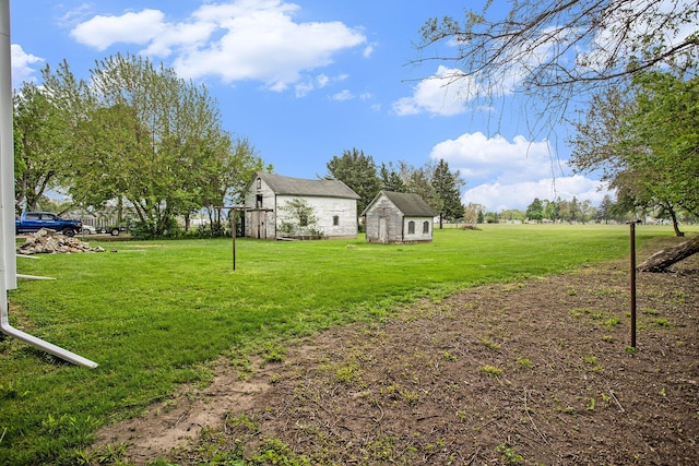 view of green lawn with an outdoor structure