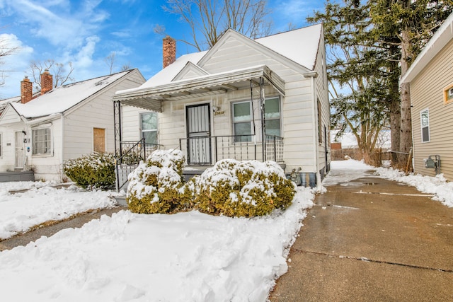 15819 Eastburn St, Detroit, MI 48205 - view of front of property featuring a porch, a chimney, and driveway