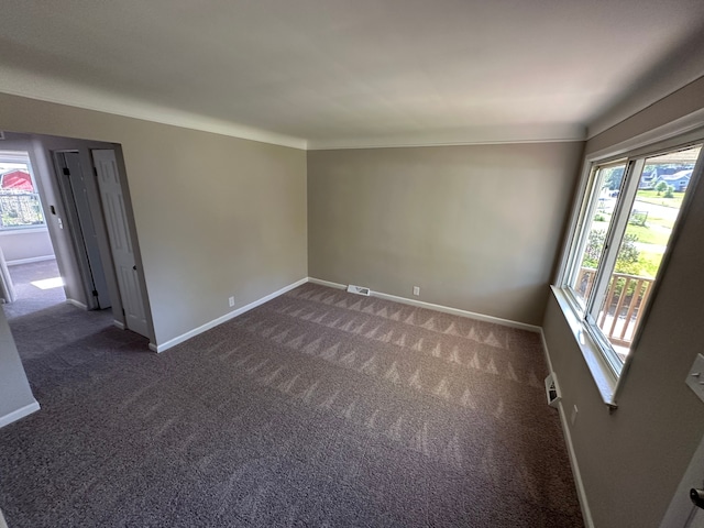 92 W Princeton Ave, Pontiac, MI 48340 - unfurnished room with baseboards, healthy amount of natural light, and dark colored carpet