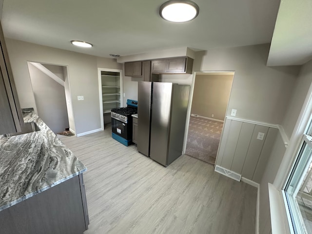 92 W Princeton Ave, Pontiac, MI 48340 - kitchen featuring range with gas cooktop, freestanding refrigerator, light wood-type flooring, and light stone countertops