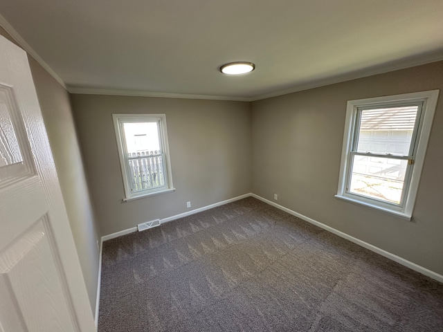 92 W Princeton Ave, Pontiac, MI 48340 - spare room featuring plenty of natural light, ornamental molding, dark colored carpet, and baseboards