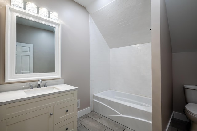 508 S Jameson St, New Buffalo, MI 49117 - bathroom featuring vaulted ceiling, toilet, baseboards, tile patterned flooring, and vanity