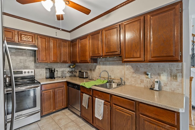 1696 S Hill Blvd, Bloomfield Hills, MI 48304 - kitchen with appliances with stainless steel finishes, under cabinet range hood, a sink, light countertops, and crown molding