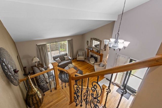 1696 S Hill Blvd, Bloomfield Hills, MI 48304 - staircase featuring a chandelier, vaulted ceiling, and wood finished floors