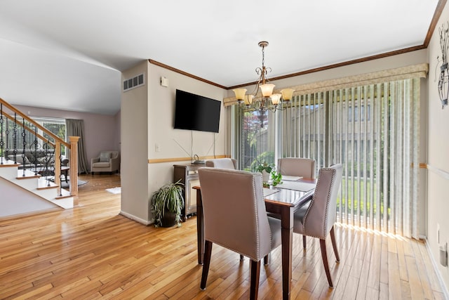 1696 S Hill Blvd, Bloomfield Hills, MI 48304 - dining area with a chandelier, stairway, wood-type flooring, baseboards, and lofted ceiling