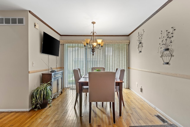 1696 S Hill Blvd, Bloomfield Hills, MI 48304 - dining room with a chandelier, baseboards, light wood-style flooring, and crown molding