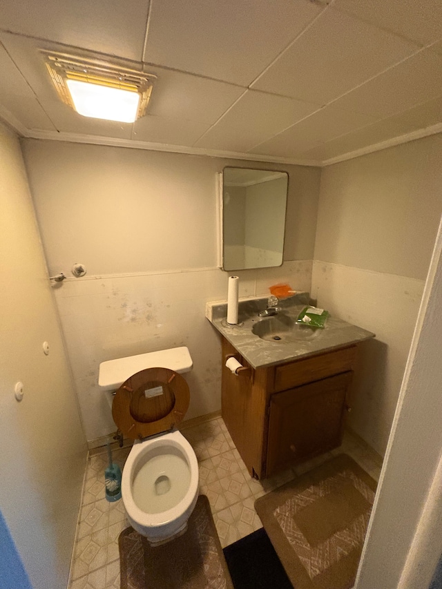 bathroom with toilet, vanity, and tile patterned floors