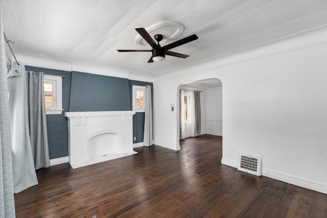 6110 Yorkshire Rd, Detroit, MI 48224 - unfurnished living room with arched walkways, ceiling fan, wood finished floors, and baseboards