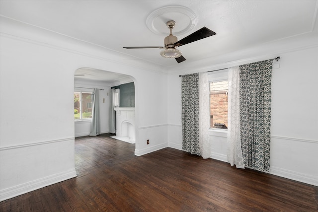 6110 Yorkshire Rd, Detroit, MI 48224 - empty room featuring arched walkways, a ceiling fan, wood finished floors, and baseboards