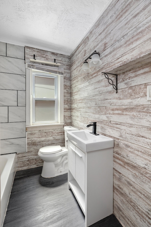 6110 Yorkshire Rd, Detroit, MI 48224 - full bath featuring vanity, toilet, a textured ceiling, wood walls, and a bathtub