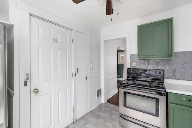 6110 Yorkshire Rd, Detroit, MI 48224 - kitchen with green cabinetry, stainless steel electric stove, arched walkways, and a ceiling fan