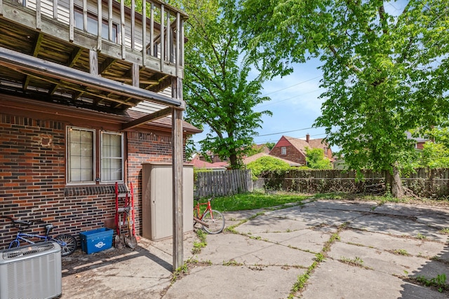 6110 Yorkshire Rd, Detroit, MI 48224 - view of patio with a fenced backyard, central AC unit, and a balcony