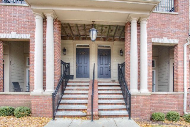 3986 Forester Blvd, Auburn Hills, MI 48326 - doorway to property featuring brick siding and covered porch