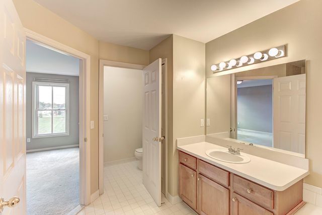 3986 Forester Blvd, Auburn Hills, MI 48326 - bathroom featuring toilet, vanity, and baseboards