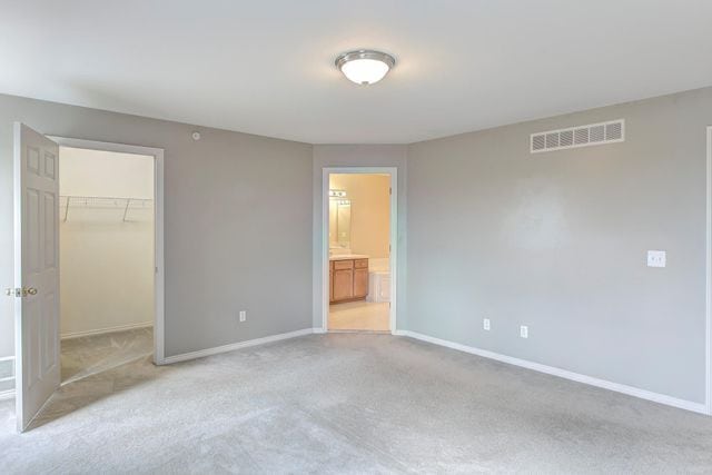 3986 Forester Blvd, Auburn Hills, MI 48326 - unfurnished bedroom featuring light carpet, a spacious closet, baseboards, a closet, and ensuite bath