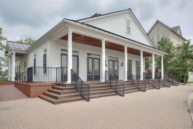 3986 Forester Blvd, Auburn Hills, MI 48326 - view of front facade with french doors, covered porch, a standing seam roof, and metal roof