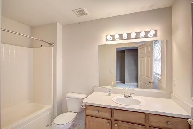 3986 Forester Blvd, Auburn Hills, MI 48326 - bathroom featuring toilet, vanity, and  shower combination