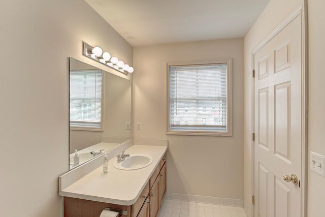 3986 Forester Blvd, Auburn Hills, MI 48326 - bathroom with plenty of natural light, vanity, and baseboards