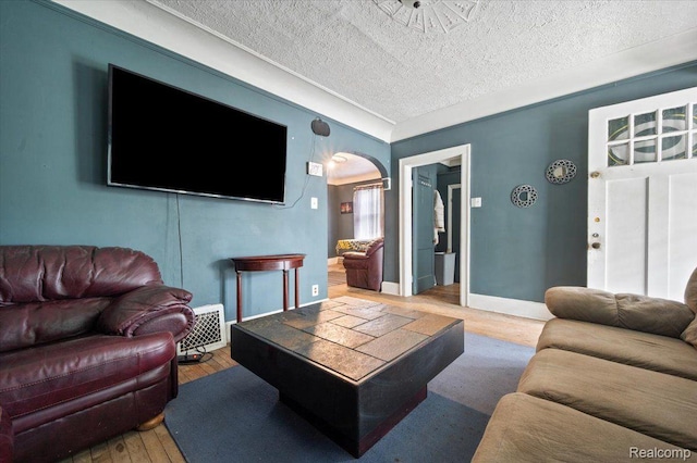 8214 Saint Marys St, Detroit, MI 48228 - living area featuring hardwood / wood-style flooring, arched walkways, and a textured ceiling