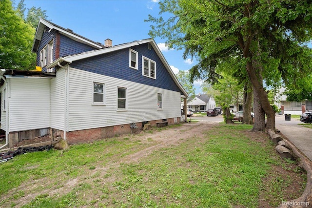 8214 Saint Marys St, Detroit, MI 48228 - view of side of home featuring a chimney and a lawn