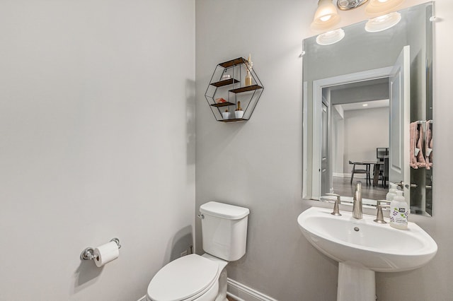 3328 Roseford Blvd, Ann Arbor, MI 48105 - half bathroom with toilet, baseboards, and a sink