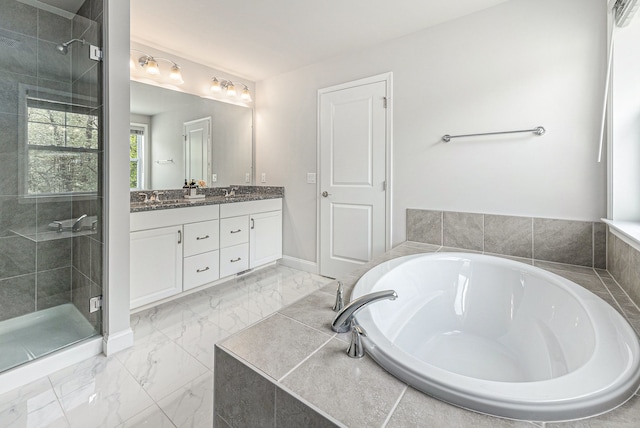 3328 Roseford Blvd, Ann Arbor, MI 48105 - full bathroom featuring a stall shower, a bath, double vanity, marble finish floors, and baseboards